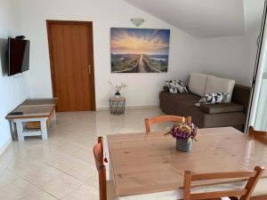 a living room with a table and a couch at Francis Appartements in Pakoštane +31 photos