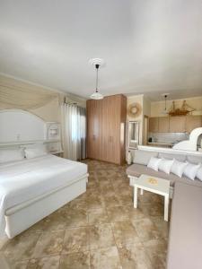 a bedroom with a large bed and a kitchen at Aggelos Studios in Adamantas