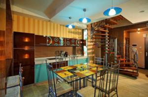 a kitchen with a table and chairs and a staircase at PARKOVY apart in Truskavets