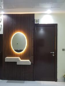 a bathroom with a mirror and a brown door at Luxurious 3bhk Villa in Dubai in Dubai