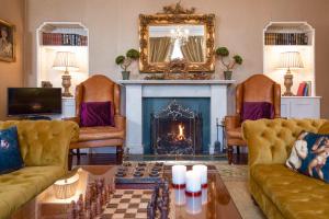 a living room with two couches and a fireplace at Easter and Christmas House Borders in Hawick