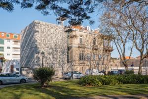 a building with a mural on the side of it at Artsy Cascais in Cascais