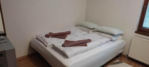 a white bed with pillows on it in a room at Apartman Željo 1 in Livno