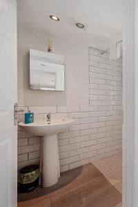 a white bathroom with a sink and a mirror at Carlisle Lodge 'Sleeping 6 guests' in Derry Londonderry