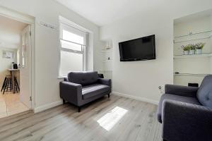 a living room with a couch and a chair and a television at Carlisle Lodge 'Sleeping 6 guests' in Derry Londonderry