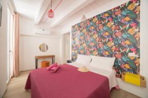 a bedroom with a large bed with a pink blanket at retroscena matrimoniale in centro in Civitanova Marche