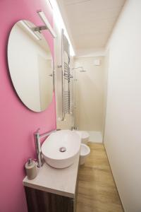 a bathroom with a white sink and a mirror at retroscena matrimoniale in centro in Civitanova Marche