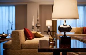 a living room with a couch and a lamp on a table at JW Marriott Hotel Chandigarh in Chandīgarh