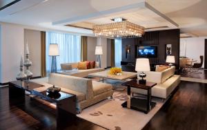 a living room filled with furniture and a chandelier at JW Marriott Hotel Chandigarh in Chandīgarh