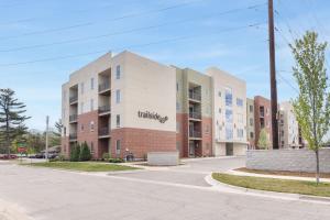 an apartment building on a street in a city at Sweet Tart Spot - Cozy TC Condo - Pet Friendly in Traverse City