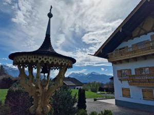 a gazebo in front of a building at Seeberghof in Frasdorf