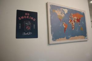 a map of the world hanging on a wall at Dudu Guesthouse Kuala Kangsar in Kuala Kangsar