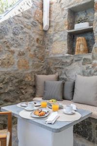 a table with food and drinks on a patio at Elena Hotel Mykonos in Mýkonos City
