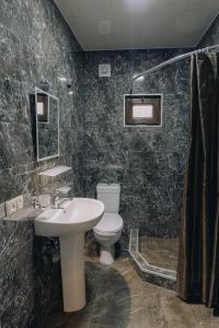 a bathroom with a sink and a toilet at Holiday Home Data in Batumi