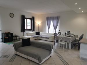 a living room with a couch and a table at Casa del vecchio faggio - Nebbiuno Lago Maggiore in Nebbiuno