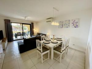 a dining room and living room with a table and chairs at Dona Lola Martha - Spacious 3 bedroom apartment with partial sea views in Mijas