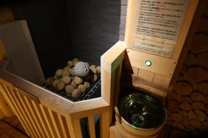 a small wooden box with rocks in it at Dormy Inn Express Fujisan Gotemba in Gotemba