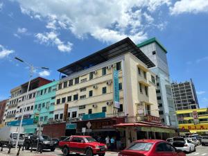ein Gebäude mit davor geparkt in der Unterkunft Hotel Tourist City Centre by HotSpot Essential in Kota Kinabalu