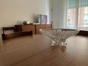 a glass bowl sitting on top of a wooden table at Best Way Rent - Casa Ida in Lavagna