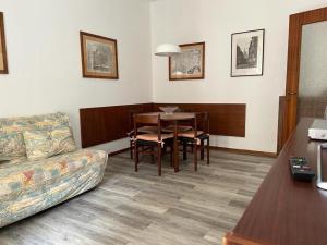 a living room with a couch and a table at Best Way Rent - Casa Ida in Lavagna