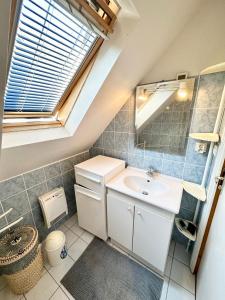 a bathroom with a sink and a mirror at Maison de charme – Terrasse – 5min des plages in Port-Louis
