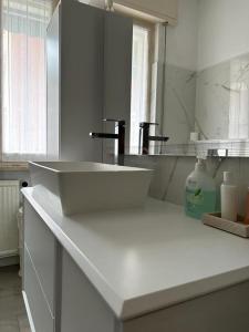 a white bathroom with a sink and a mirror at Best Way Rent - Casa Ida in Lavagna +17 photos
