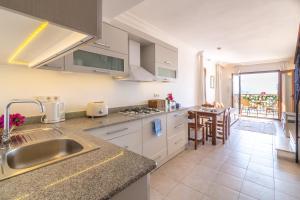 a kitchen with a sink and a counter top at Korsan Apartment No.12 in Kaş