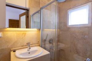 a bathroom with a sink and a shower at Korsan Apartment No.12 in Kaş