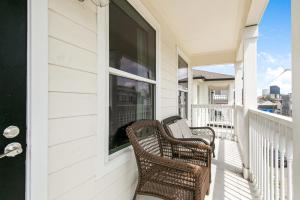 two wicker chairs sitting on the porch of a house at Breathtaking Condos Near French Quarter in New Orleans