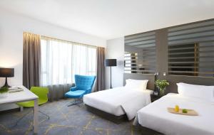A bed or beds in a room at The Cityview - Chinese YMCA of Hong Kong
