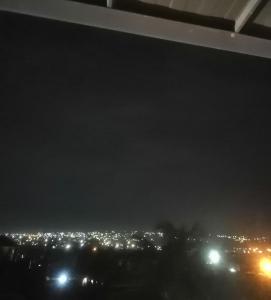 a view of a city at night with lights at Terra Santa Lodgings in Accra