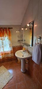 a bathroom with a sink and a mirror at Eni's Villa, 5km From Shengjini Beach in Lezhë