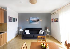 a living room with a couch and a table at Apartment Zen u Postira in Postira