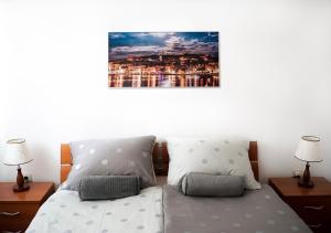 a bedroom with a bed with two pillows and two lamps at Apartment Zen u Postira in Postira +15 photos