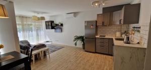 a kitchen with a stainless steel refrigerator in a room at Jaukūs apartamentai Free parking in Vilnius