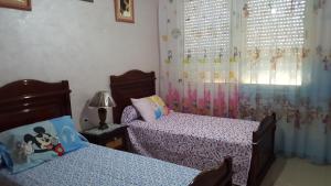 Postel nebo postele na pokoji v ubytování Residence Al Massira