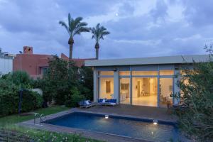 a house with a swimming pool in the backyard at Beach House Galei in Herzliyya B