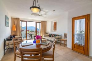a living room with a table and chairs and a dining room at Korsan Apartment No.16 in Kaş