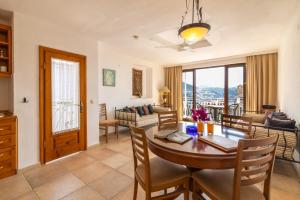 a dining room and living room with a table and chairs at Korsan Apartment No.16 in Kaş