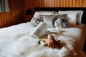 a bedroom with a white bed with a white blanket at Tatra House z Jacuzzi in Poronin +136 photos