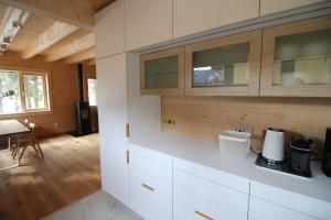 a kitchen with white cabinets and a wooden floor at aeki BLOCK in Imst