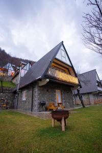 a house with a roof with a bench in front of it at Columbus Villas in Vermosh +33 photos