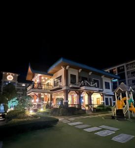 un grande edificio di notte con le luci accese di CozyVilla at Pine Suites Tagaytay 2BR or Studio with FREE PARKING 2br in Basement parking and studio in offsite parking a Tagaytay
