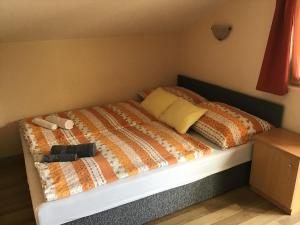 a bedroom with a bed with two towels on it at Drávecz Apartman in Balatonlelle