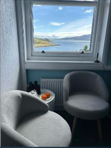 two chairs in front of a window with a view at Castle View in Lochaline