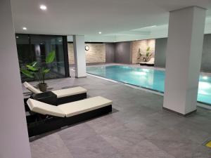 a living room with a swimming pool in a house at Ferienresort mit Pool am Schluchsee in Schluchsee