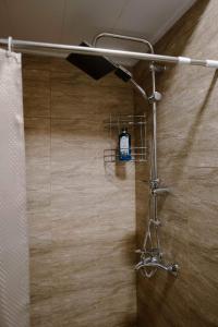 łazienka z prysznicem z zasłoną prysznicową w obiekcie GERGETI Arsenas Guest House w mieście Stepancminda