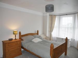 a bedroom with a bed and a dresser and a window at Close to beaches and town, off street parking in Kent