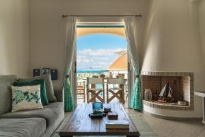 Una sala de estar con un sofá y una chimenea. en Villa Millianna - Ground Floor Apt, en Cefalonia