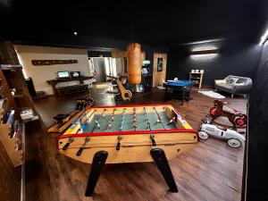 a room with a pool table in the middle of a room at Fontaine du Mont Blanc Hotel & Spa in Les Houches